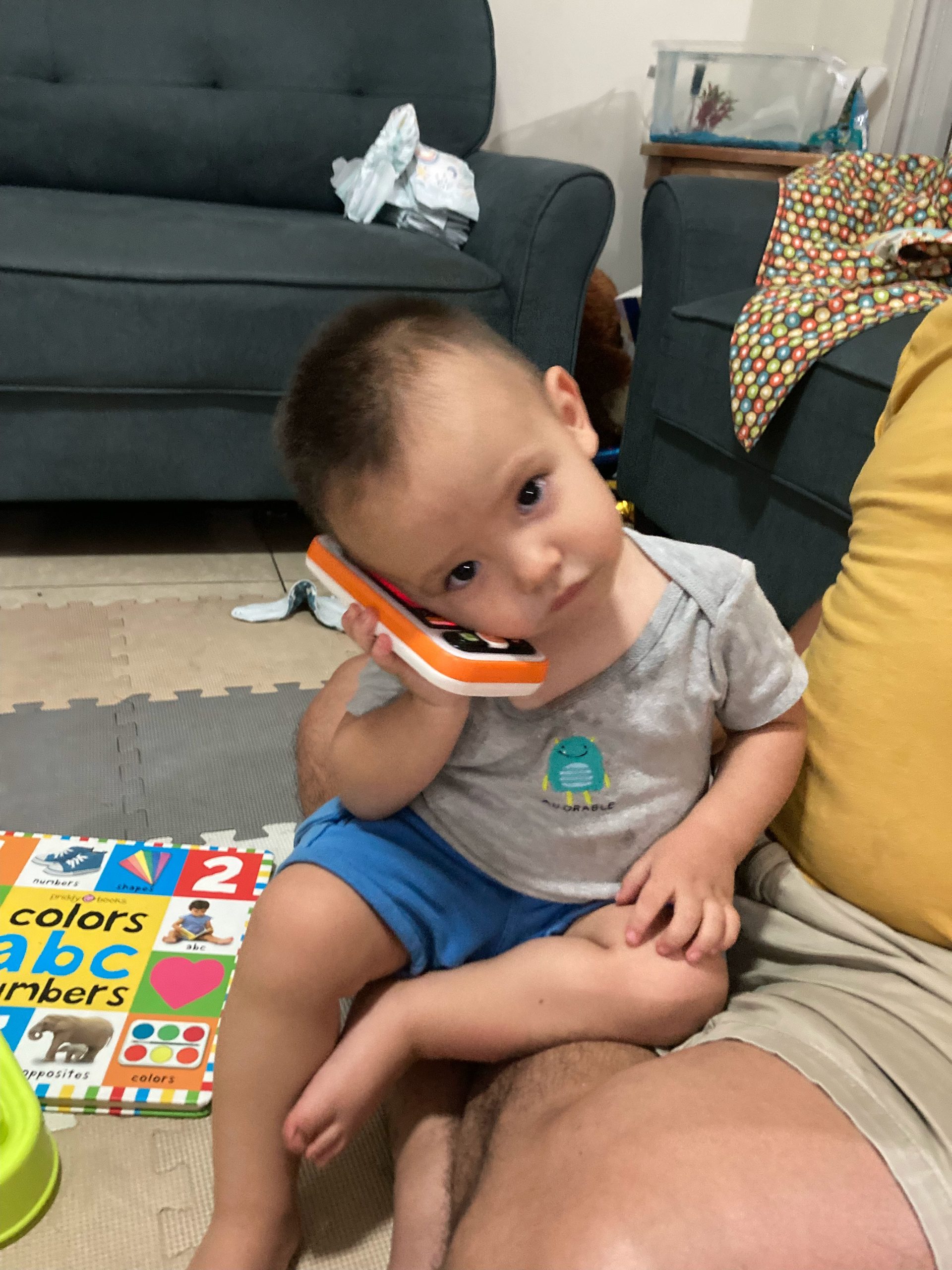 Baby holding a toy cell phone, illustrating a family guide to El Salvador SIM cards and eSIMs